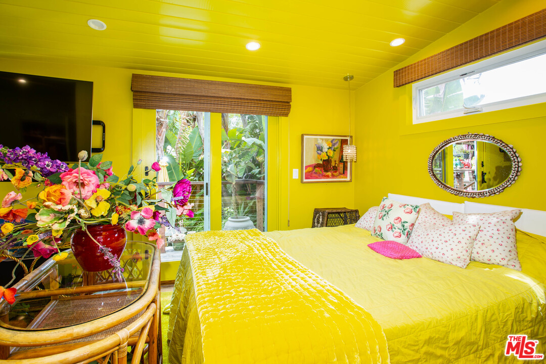 232 Paradise Cove Road Malibu, CA 90265 - Photo 11 of 38 a bedroom with a bed and a chandelier