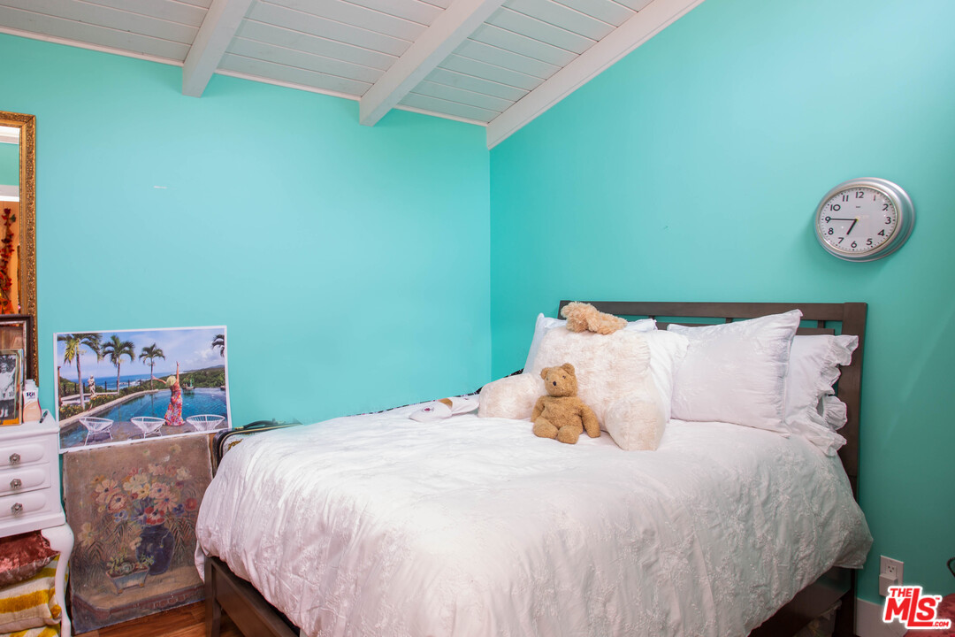 232 Paradise Cove Road Malibu, CA 90265 - Photo 16 of 38 a bedroom with a bed and painting on the wall