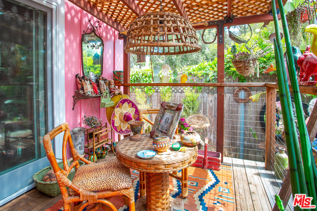 232 Paradise Cove Road Malibu, CA 90265 - Photo 21 of 38 a view of an chairs and table in patio with a yard