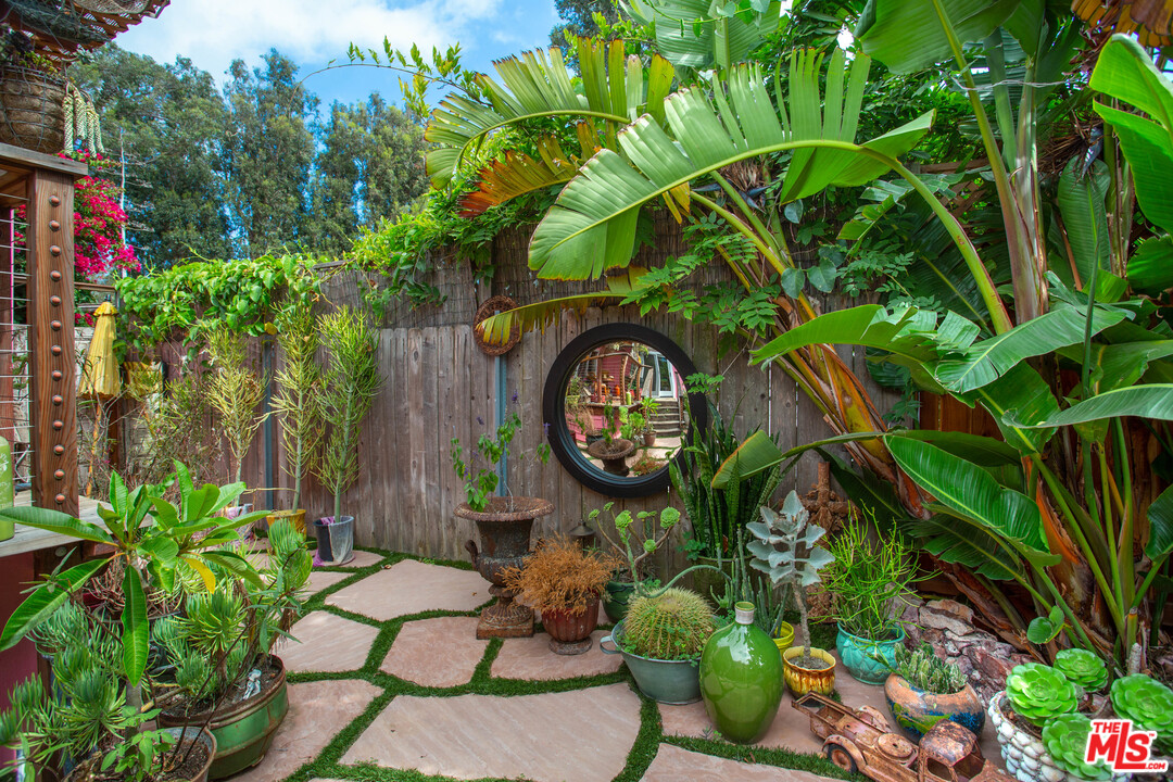 232 Paradise Cove Road Malibu, CA 90265 - Photo 25 of 38 a backyard of a house with lots of green space and a fountain