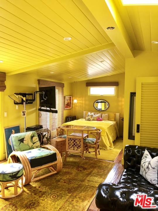 232 Paradise Cove Road Malibu, CA 90265 - Photo 10 of 38 a bedroom with furniture and a flat screen tv