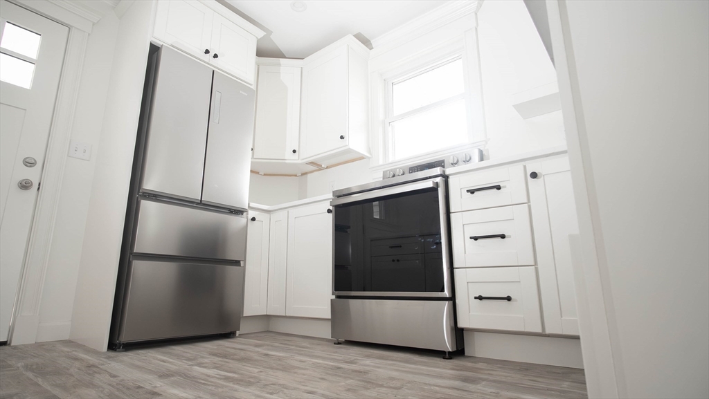 1165 Nantasket Avenue Hull, MA 02045 - Photo 12 of 39 a kitchen with stainless steel appliances granite countertop a refrigerator and a sink