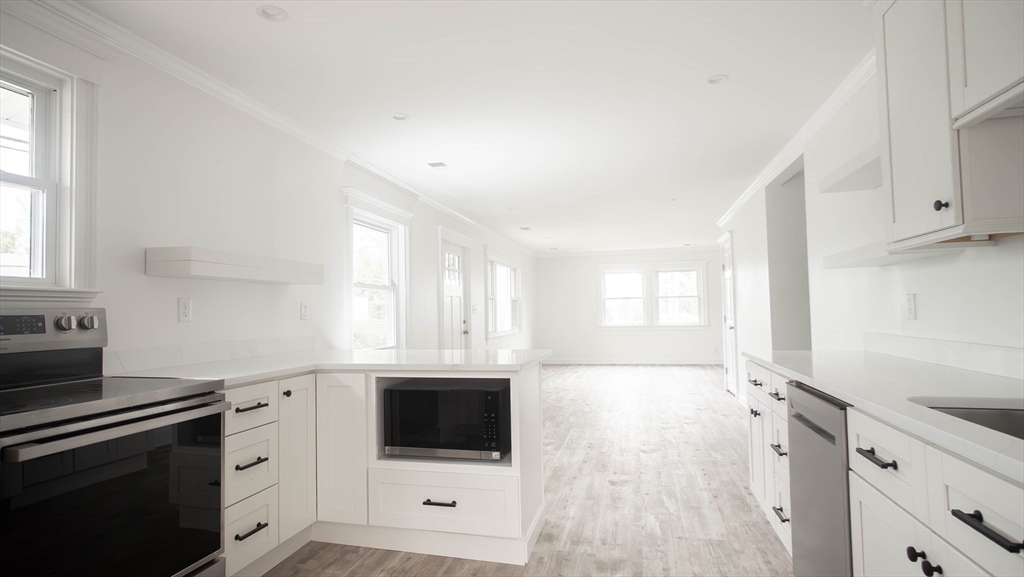 1165 Nantasket Avenue Hull, MA 02045 - Photo 15 of 39 a kitchen with a sink stove and cabinets
