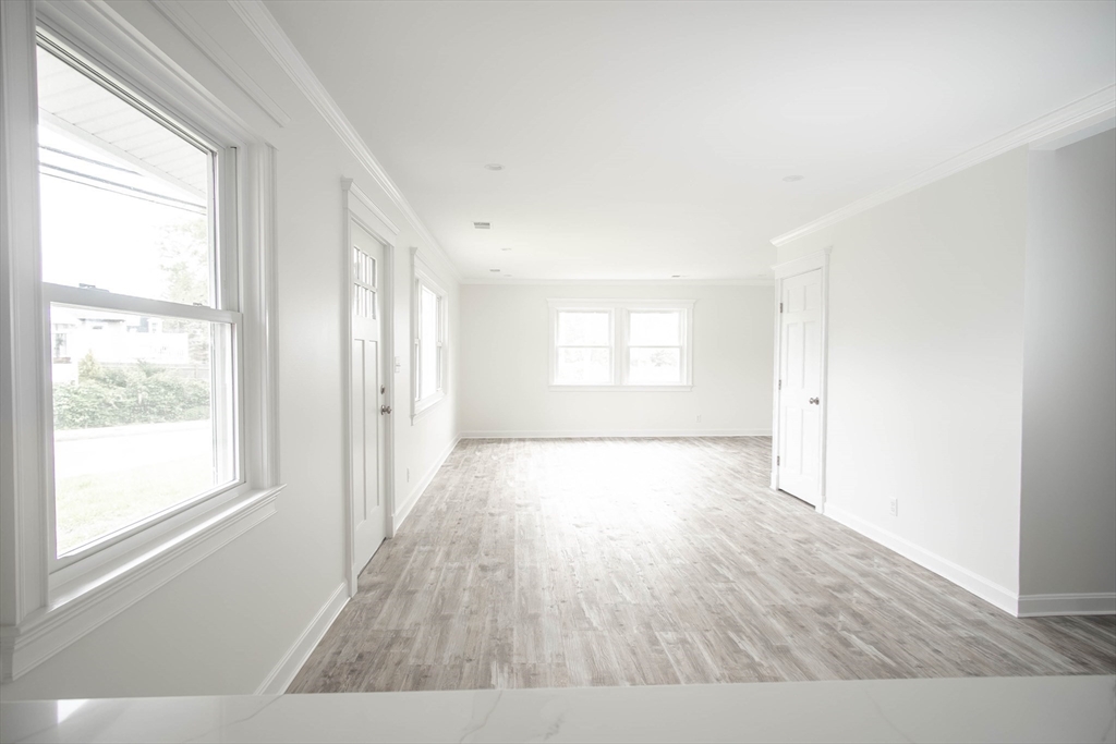 1165 Nantasket Avenue Hull, MA 02045 - Photo 16 of 39 a view of an empty room with wooden floor and a window