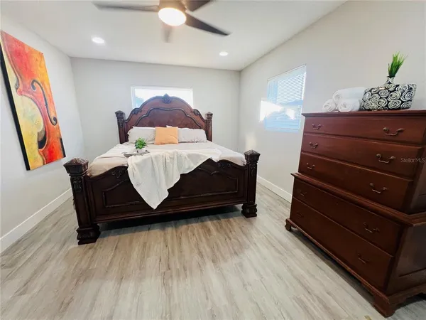 a bed sitting in a bedroom next to a window