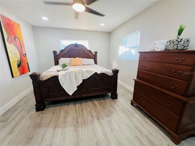 a bed sitting in a bedroom next to a window