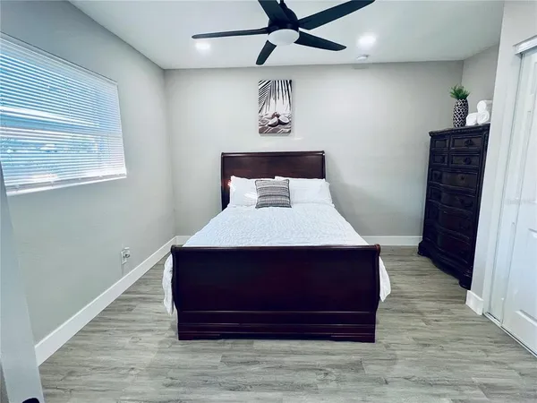 a bedroom with a bed and painting on the wall