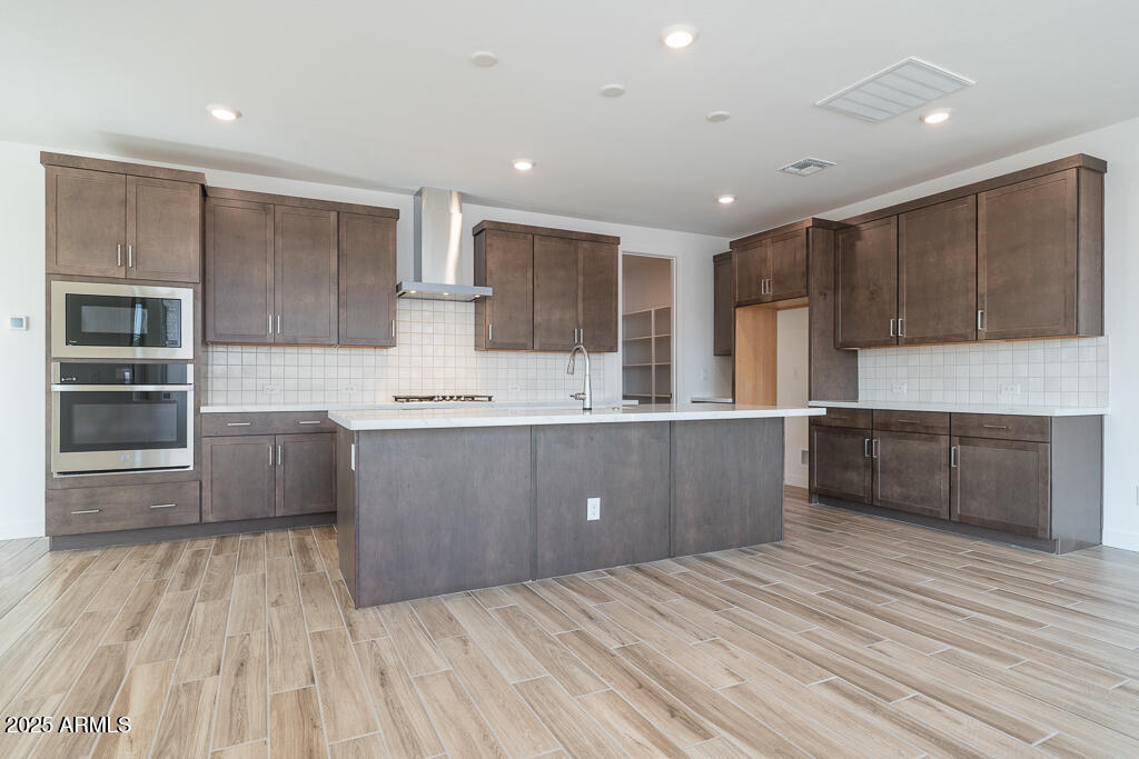 5927 South Granite Street Gilbert, AZ 85298 - Photo 2 of 20 a open kitchen with kitchen island a sink stainless steel appliances and cabinets