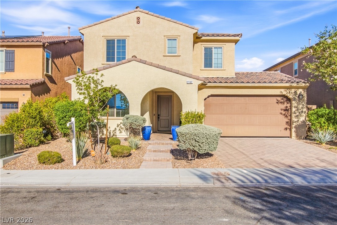 2182 Trivero Street Henderson, NV 89044 - Photo 3 of 50 Spanish tile roofing and stucco siding define this two-story residential facade.