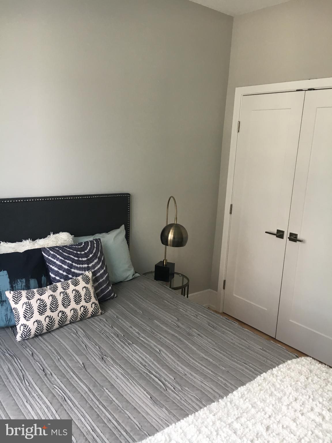 1008 South 17th Street, Unit A Philadelphia, PA 19146 - Photo 12 of 13 a bedroom with a bed and wooden floor