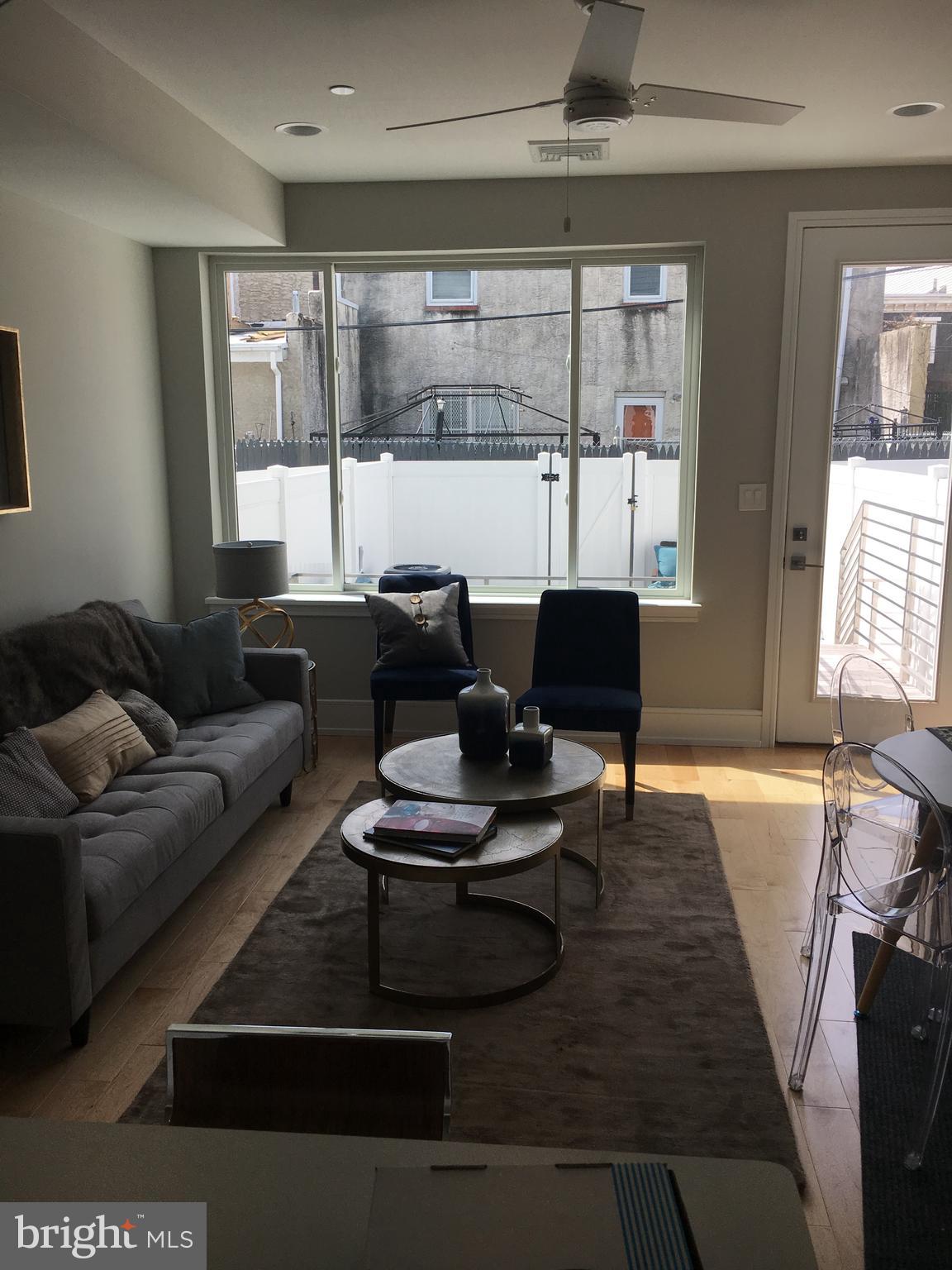 1008 South 17th Street, Unit A Philadelphia, PA 19146 - Photo 4 of 13 a living room with furniture and a large window