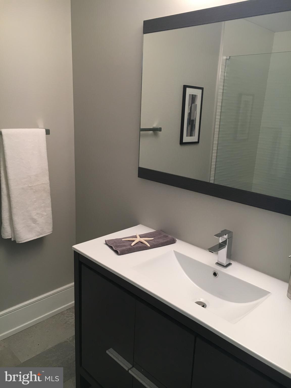1008 South 17th Street, Unit A Philadelphia, PA 19146 - Photo 10 of 13 a bathroom with a sink and a mirror