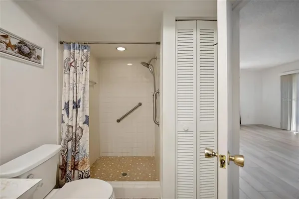 a bathroom with a shower a toilet and a shower