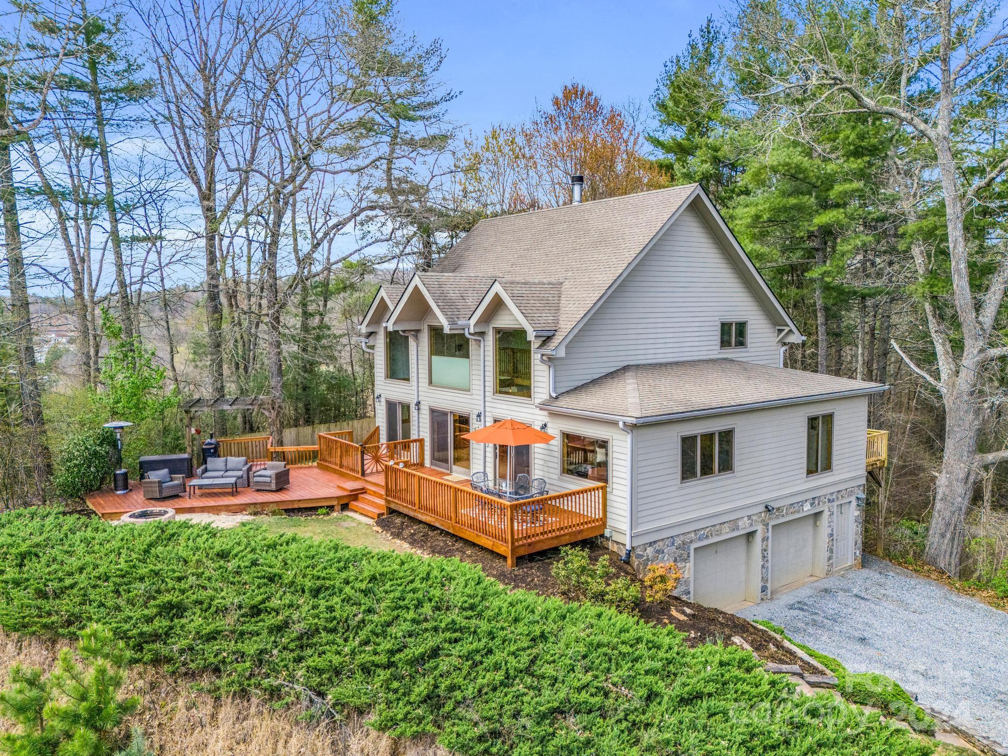255 Oscar Young Road Mars Hill, NC 28754 - Photo 2 of 48 an aerial view of a house with a big yard potted plants and large tree