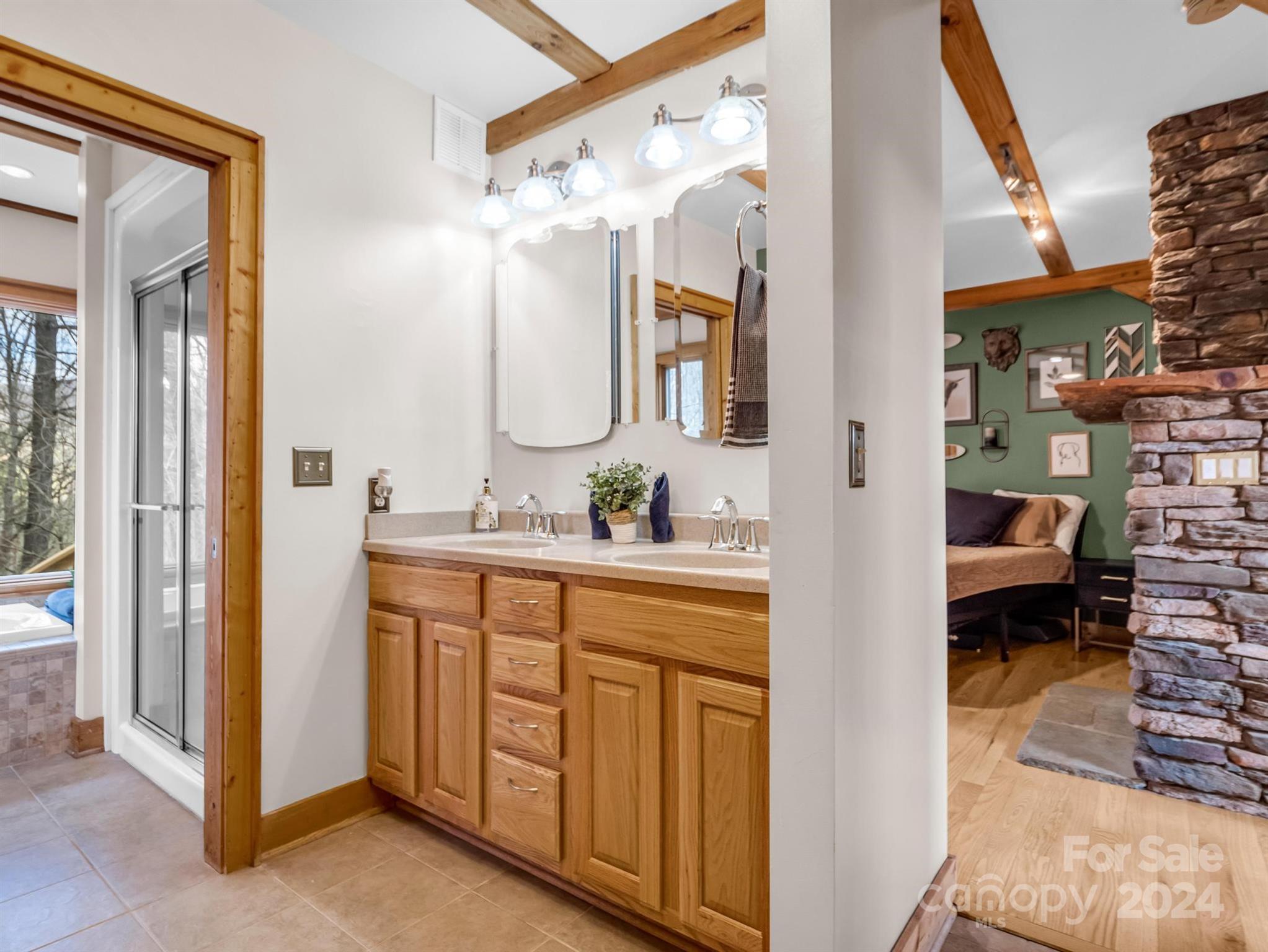 255 Oscar Young Road Mars Hill, NC 28754 - Photo 28 of 48 a spacious bathroom with a double vanity sink and a mirror