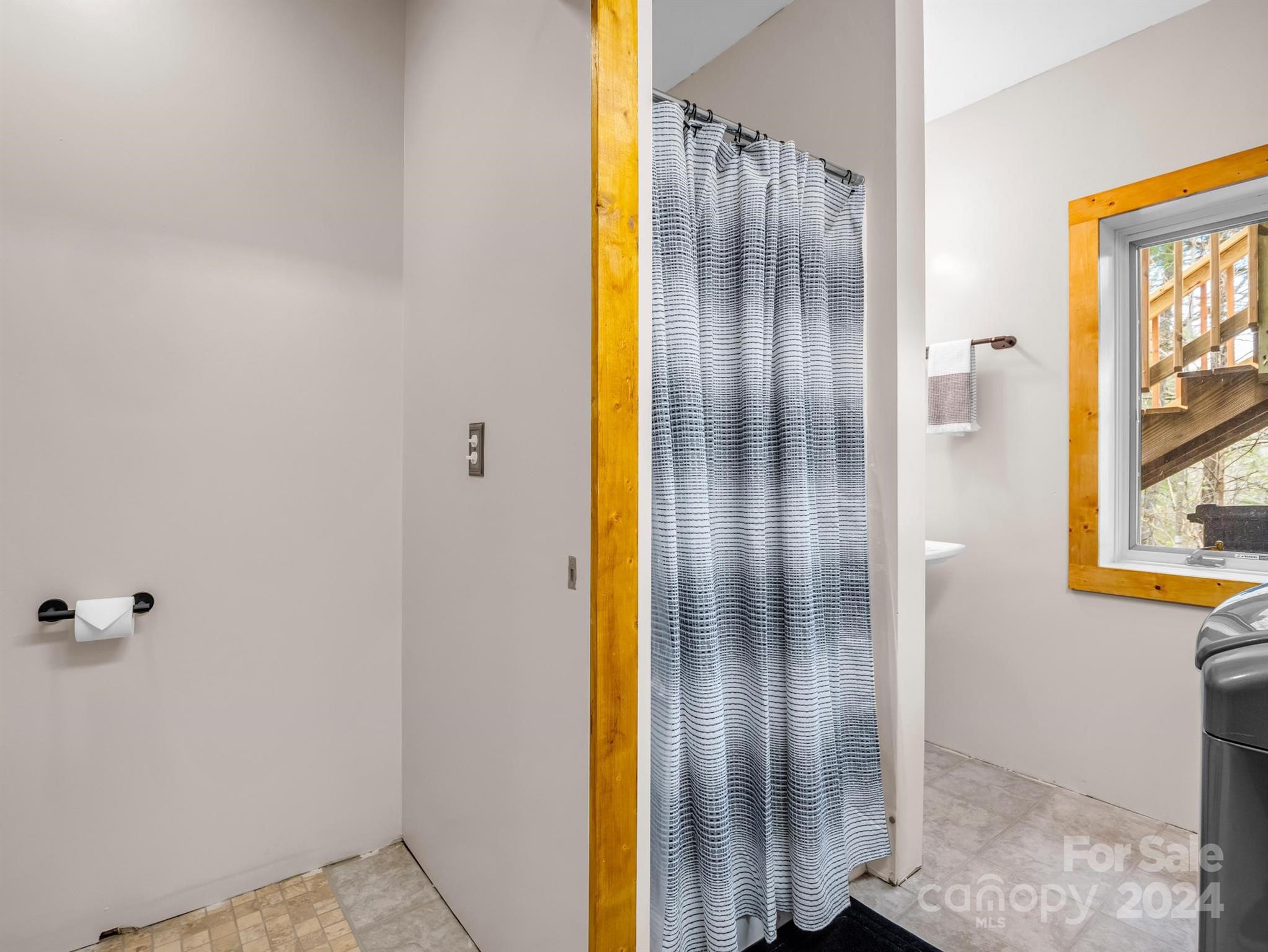 255 Oscar Young Road Mars Hill, NC 28754 - Photo 42 of 48 a bathroom with a glass shower door