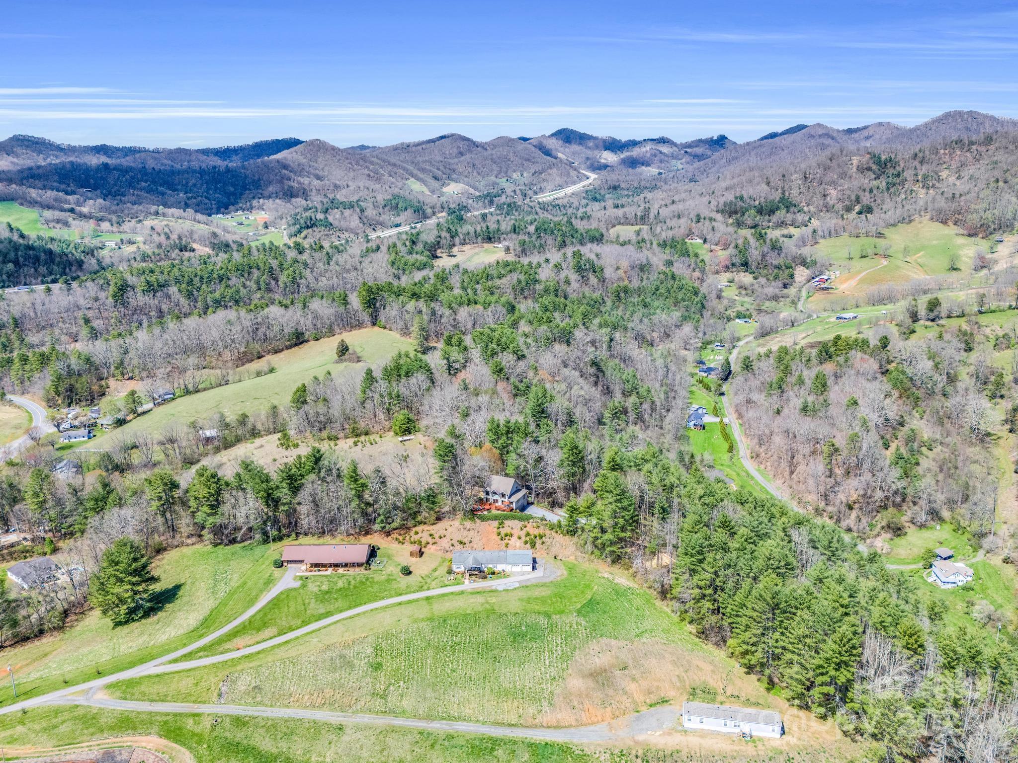 255 Oscar Young Road Mars Hill, NC 28754 - Photo 48 of 48 a view of a lush green hillside and houses