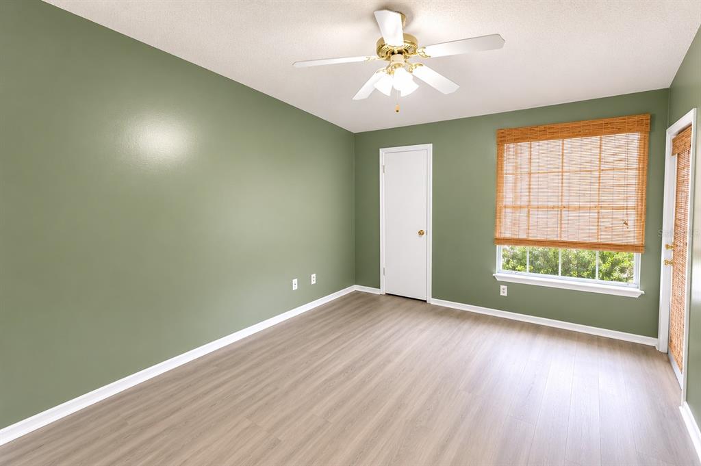 1908 Lake Atriums Circle, Unit 9 Orlando, FL 32839 - Photo 8 of 11 an empty room with wooden floor and windows