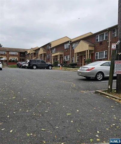 a front view of a house with parking space