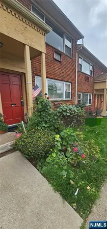 a front view of a building with garden