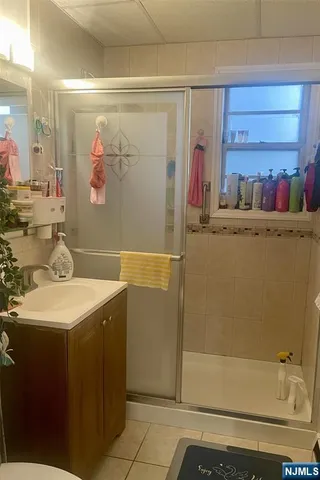 a bathroom with a sink mirror and a shower