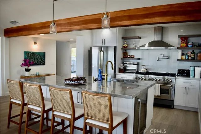 a kitchen with stainless steel appliances granite countertop a stove a sink and a refrigerator