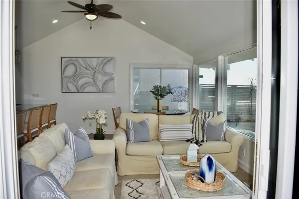 a living room with furniture and a painting on the wall