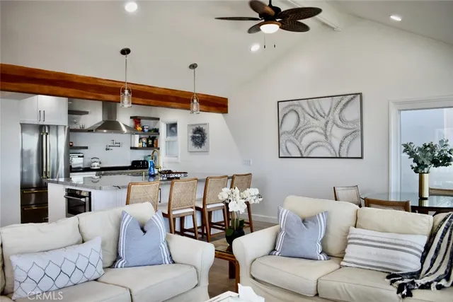 a living room with furniture and kitchen view
