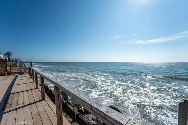 a view of roof deck with wooden floor and fence