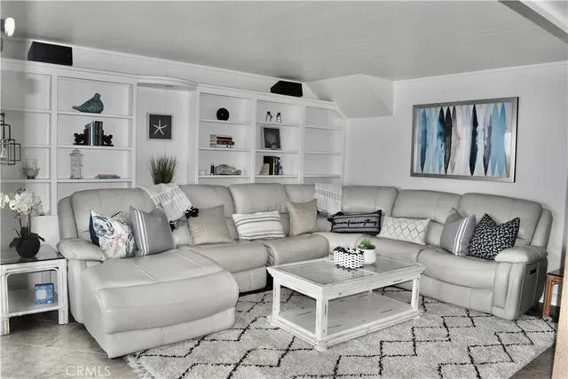 a living room with furniture and view of kitchen