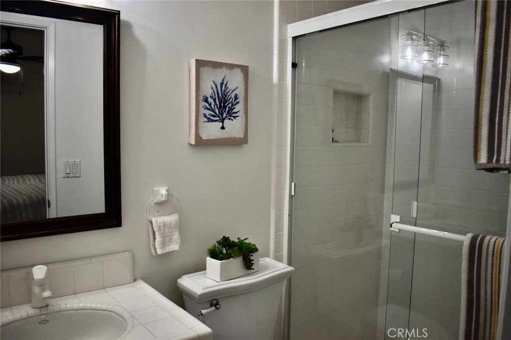 35605 Beach Road Dana Point, CA 92624 - Photo 29 of 55 a bathroom with a toilet sink and mirror
