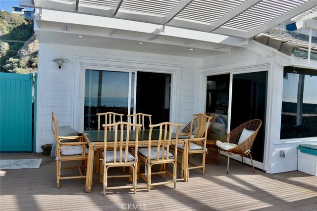 a view of a chairs and table in a patio