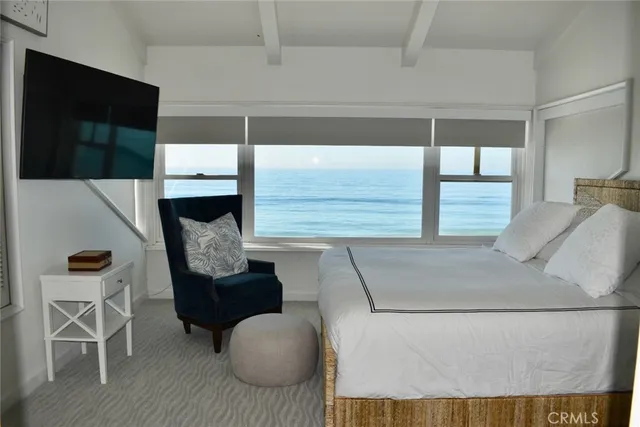 a view of a small room with a large window with a flower pot