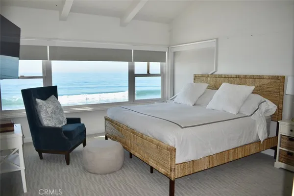 a bedroom with two beds and painting on the wall