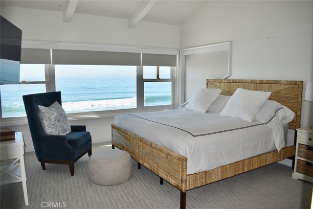 a bedroom with two beds and painting on the wall