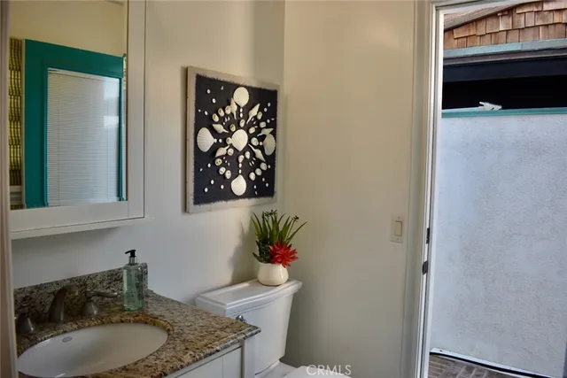 a view of a rooftop deck with couch and chairs