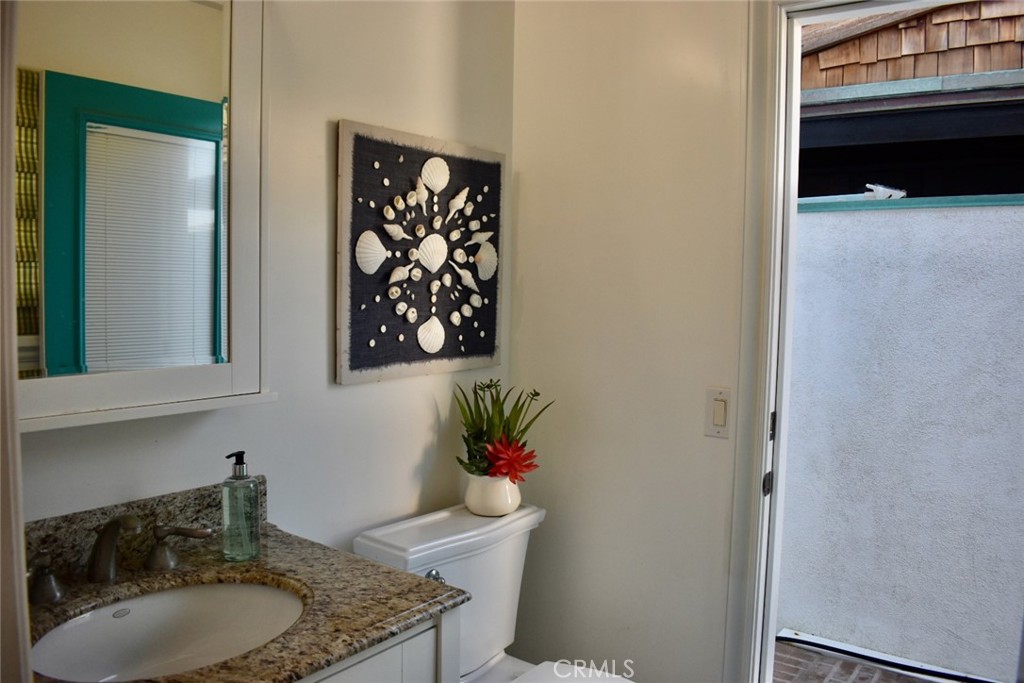 35605 Beach Road Dana Point, CA 92624 - Photo 48 of 55 a bathroom with a granite countertop sink a mirror and vanity
