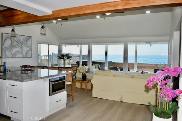 a view of living room with furniture and large windows