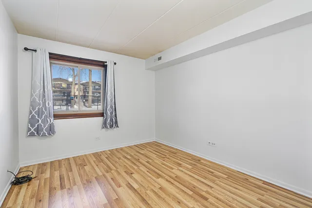 a view of a room with wooden floor and windows