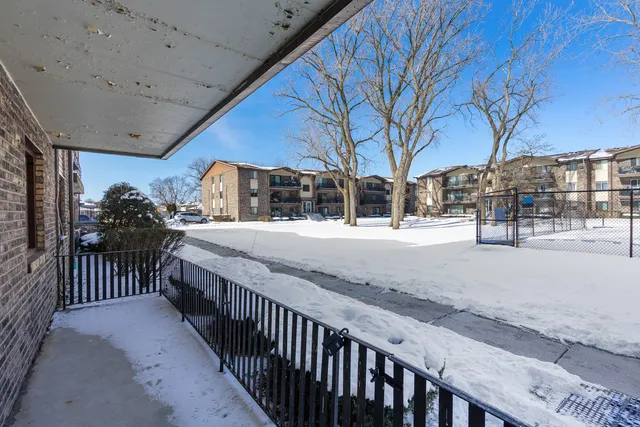 a view of a porch with snow on the side of the road