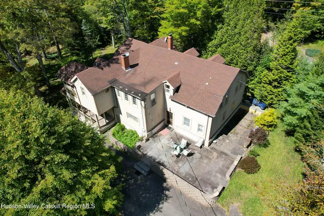 an aerial view of a house with a yard