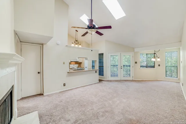 a view of a livingroom with an empty space and a ceiling fan
