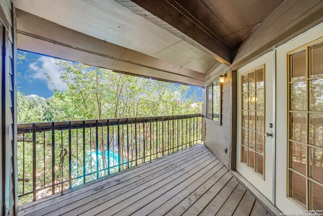 a view of a balcony with wooden floor