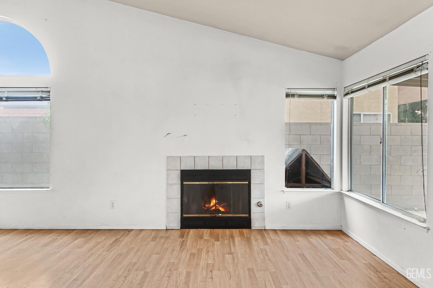 Undisclosed Address Bakersfield, CA 93313 - Photo 12 of 34 a view of an empty room with a window and wooden floor