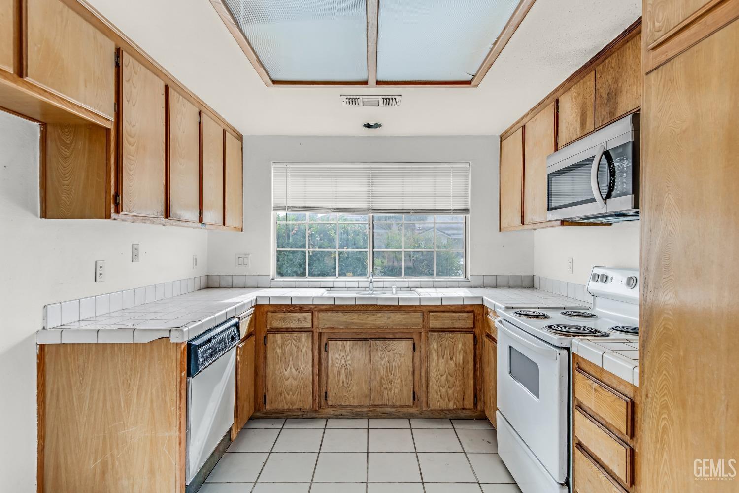 Undisclosed Address Bakersfield, CA 93313 - Photo 13 of 34 a kitchen with stainless steel appliances granite countertop a sink stove and cabinets