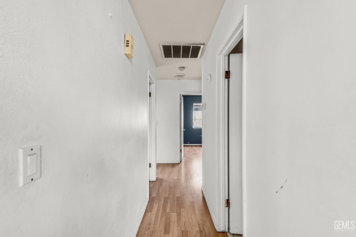 Undisclosed Address Bakersfield, CA 93313 - Photo 14 of 34 a view of a hallway with wooden floor and staircase