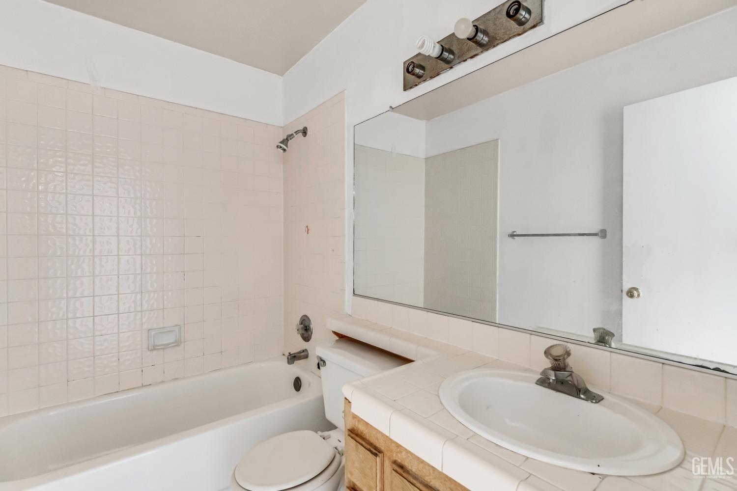 Undisclosed Address Bakersfield, CA 93313 - Photo 15 of 34 a bathroom with a sink a toilet and a bathtub