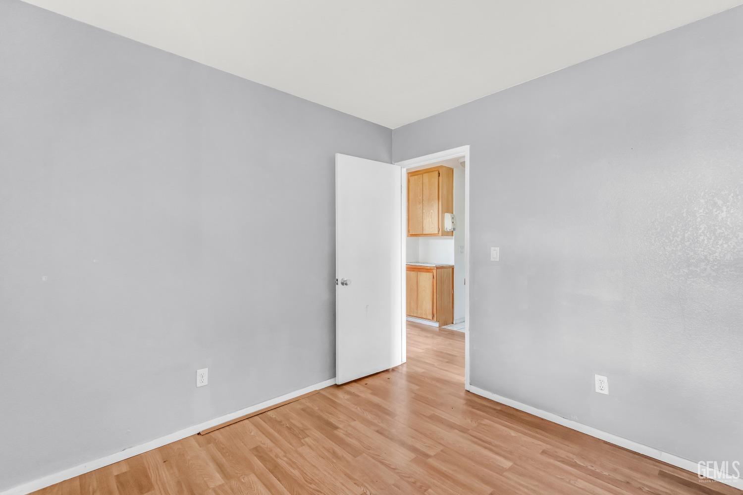 Undisclosed Address Bakersfield, CA 93313 - Photo 17 of 34 a view of an empty room and wooden floor