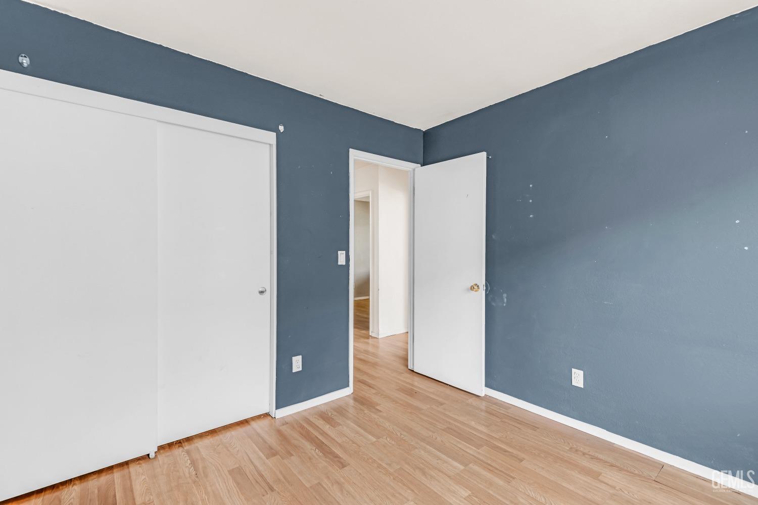 Undisclosed Address Bakersfield, CA 93313 - Photo 19 of 34 a view of an empty room with wooden floor