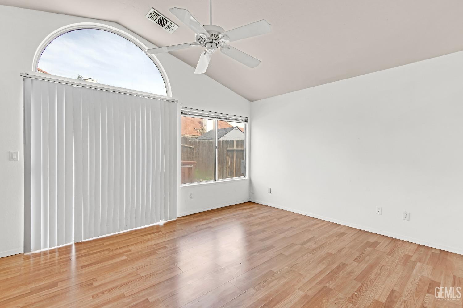 Undisclosed Address Bakersfield, CA 93313 - Photo 21 of 34 an empty room with wooden floor fan and windows